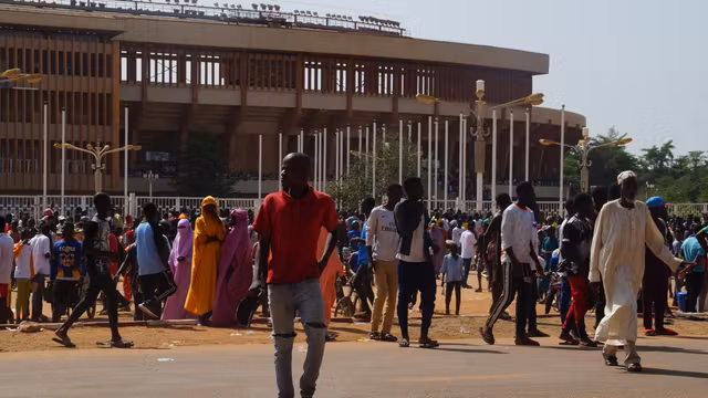Nigeriens gather near the General Seyni Kountché stadium in Niamey for a civilian militia recruitment session.