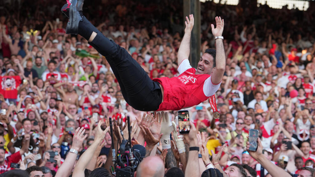 Arsenal manager Mikel Arteta is carried in triumph by players celebrating their Premier League title after the English Premier League football match between Crystal Palace and Arsenal in London, England, Sunday, May 24, 2026.
