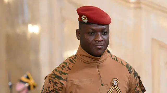 Burkina Faso's military leader Ibrahim Traore wearing a red military cap and uniform