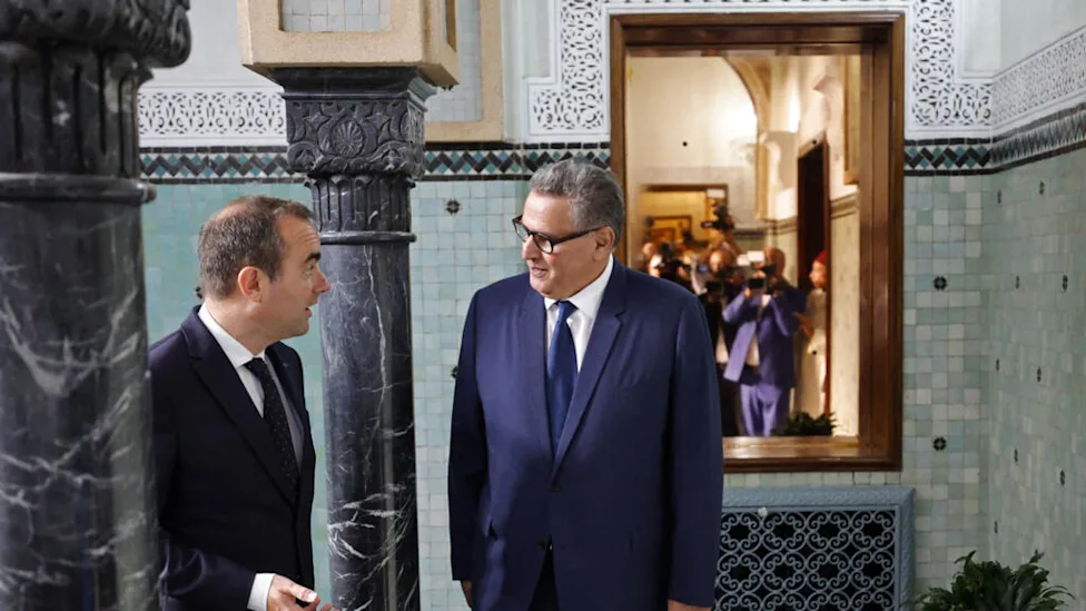 Diplomatic officials from Morocco and France shaking hands in Rabat