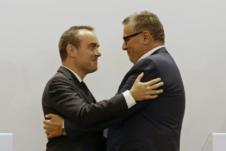 French and Moroccan leaders embrace after a joint press conference in Rabat