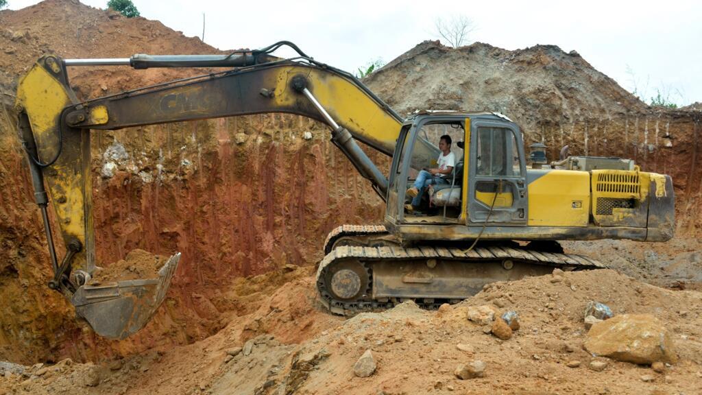 A Chinese mining employee operates a bulldozer at a gold mining site in Betare Oya, Cameroon, April 4, 2018.