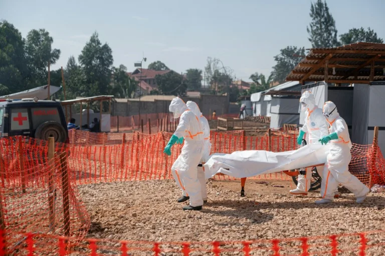 Health workers in protective gear handling medical supplies in a high-risk Ebola zone