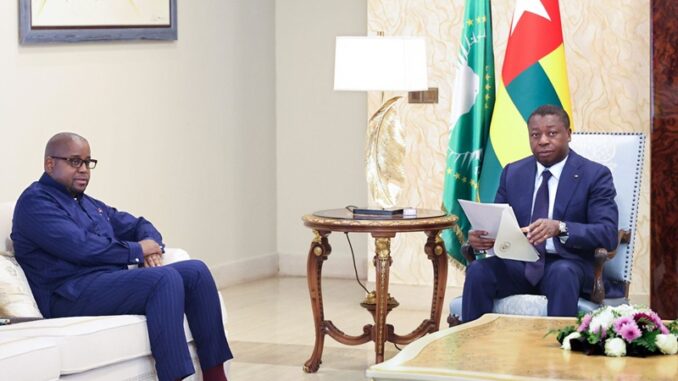 Togolese diplomat Faure Gnassingbé seated at a formal meeting table during a high-level African Union peace talks discussion